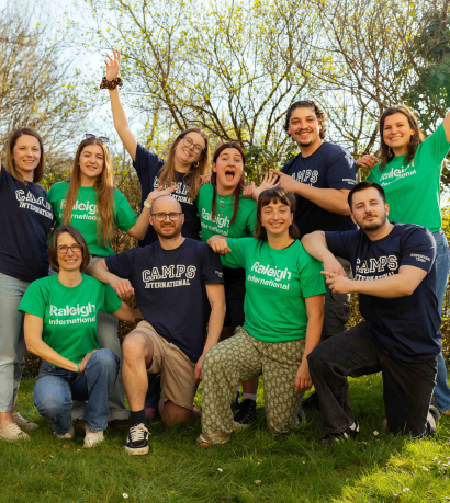 Employees from Camps International and Raleigh International came to celebrate partnership wearing their respective blue and green branded t-shirts