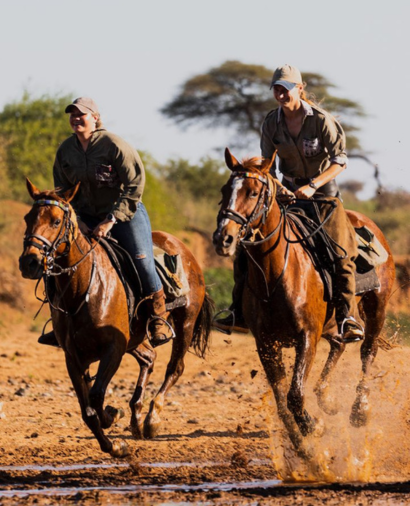Two riders on horseback galloping on an African Horse Safaris riding holiday.