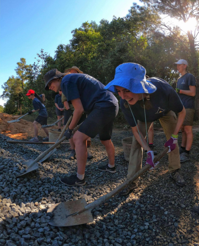 Students on a Camps International school expedition working together on an infrastructure based project.