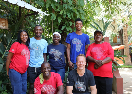 Meet our people behind the Impact Travel Group: Photo in Livingstone, Zambia. Team wearing colourful African Impact t-shirts