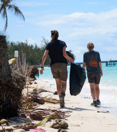 Two volunteers cleaning at the beach