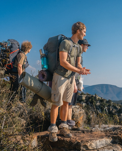 Three people with backpacks on a trek in South Africa with Raleigh