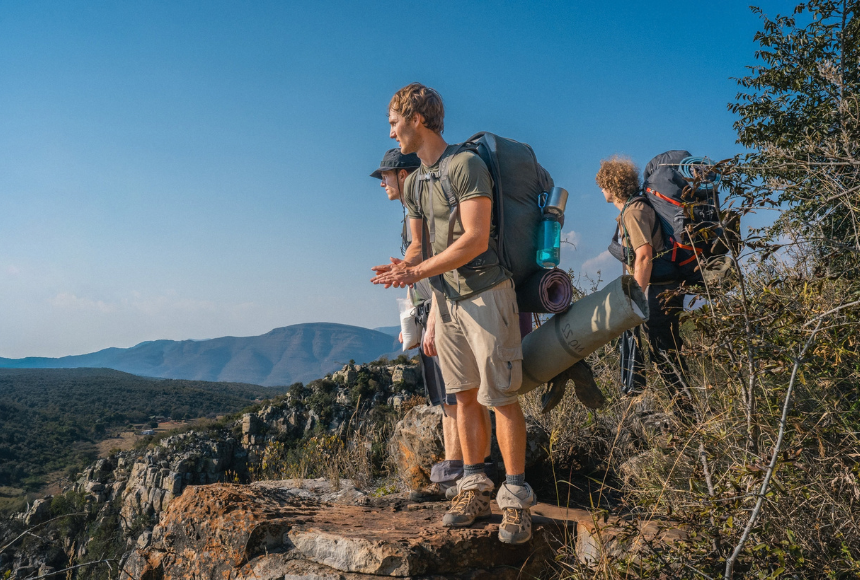 Three people with backpacks on a trek in South Africa with Raleigh